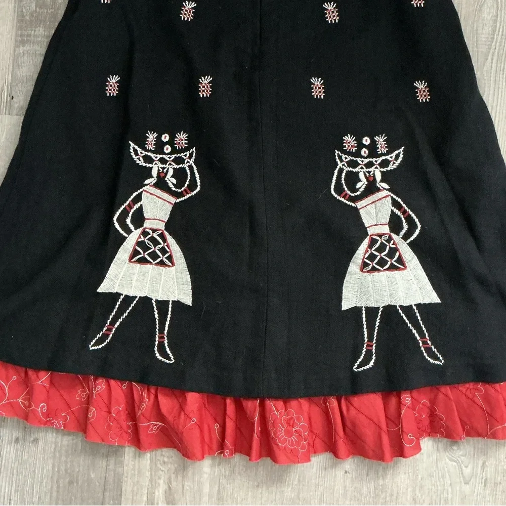 A-line midi skirt with white and red embroidered figures and a ruffled red hem🌻